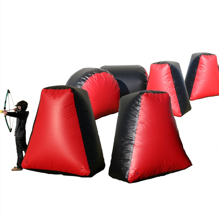 Red and black inflatable Archery Tag bunkers arranged as a playing field