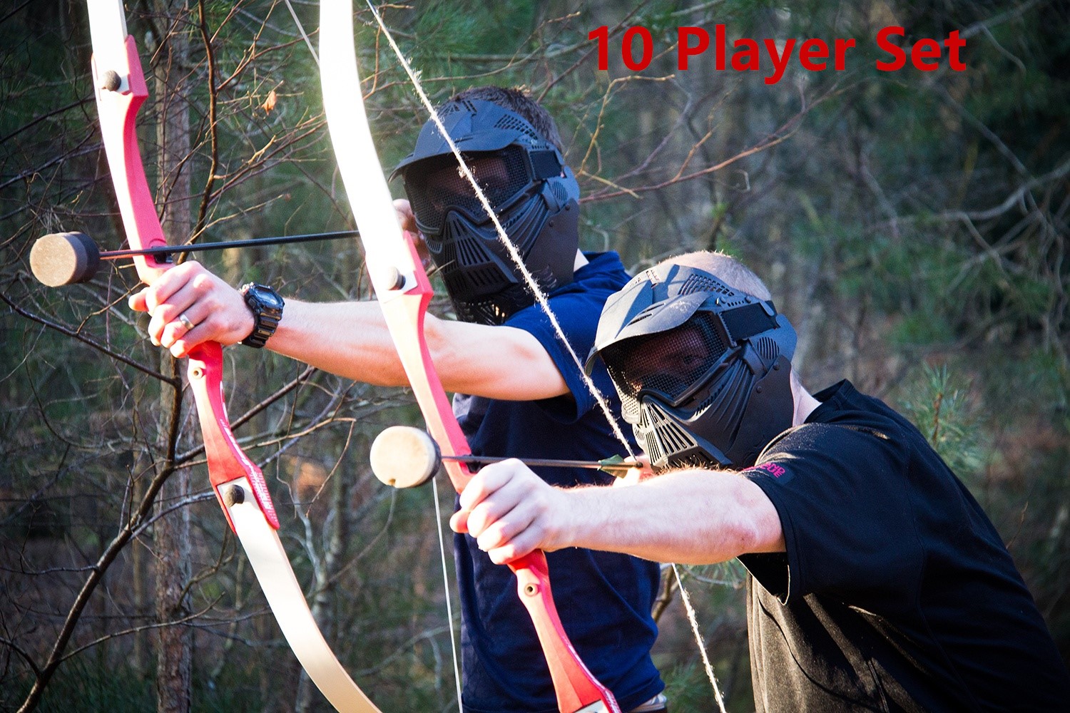 Two masked Archery Tag players aiming foam-tip arrows outdoors